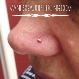 Nostril piercing with yellow gold tri-bead cluster